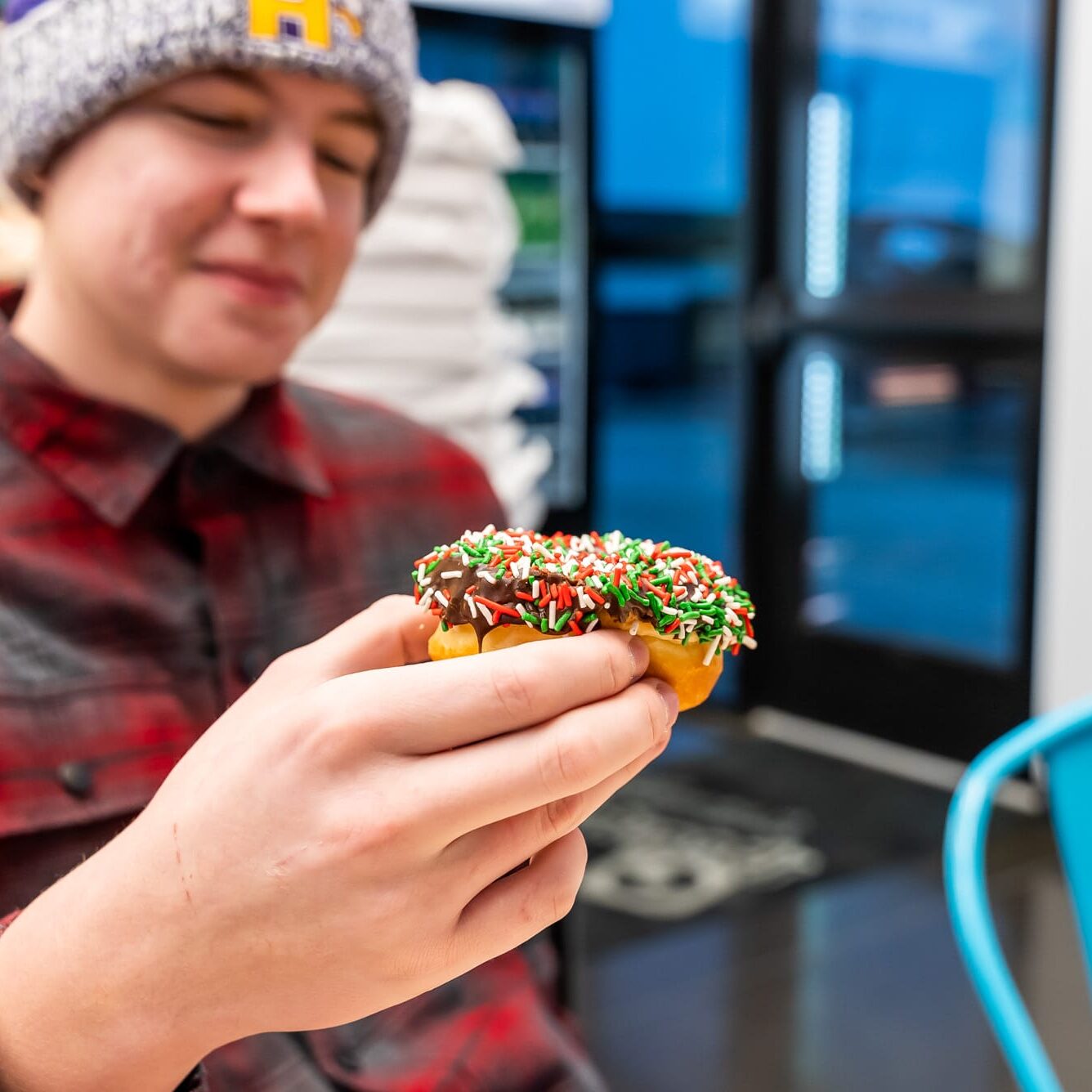 man eating a sprinkled spudnut