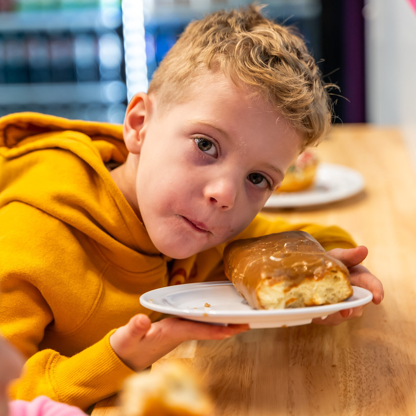 Spudnuts_lifestyle_0109 child holding a maple bar