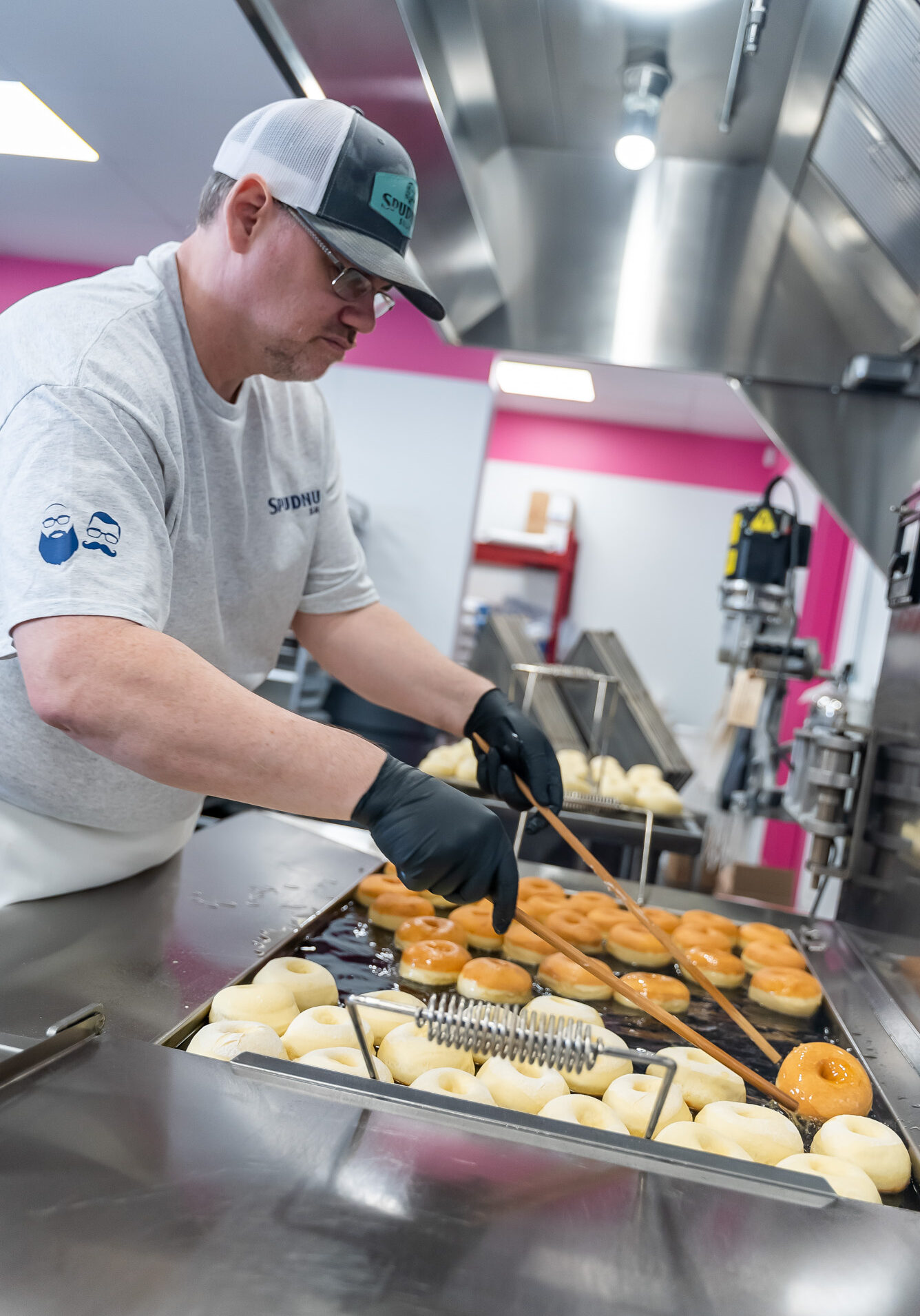 Spudnuts_process_0267 baker flipping spudnuts in the fryer